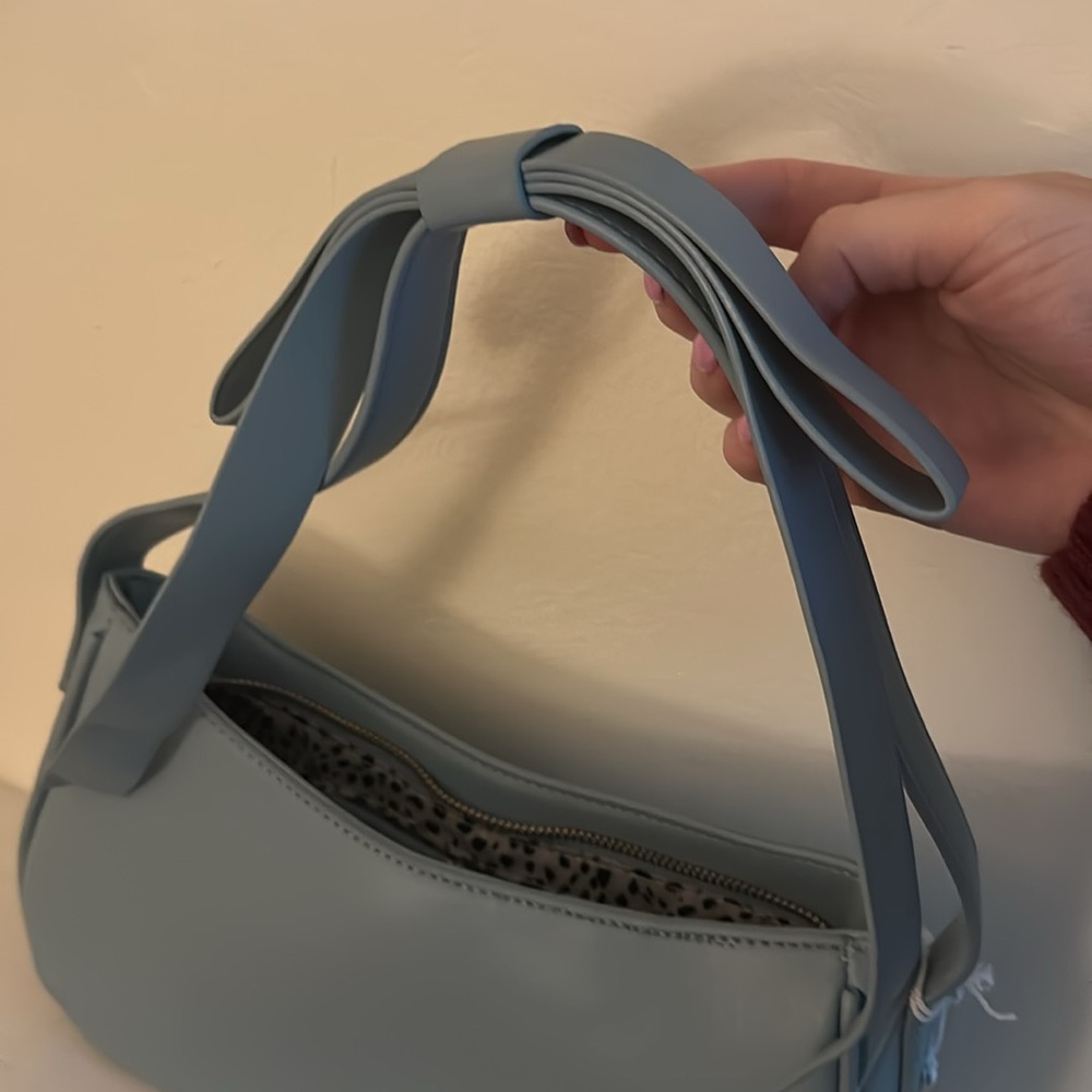 Powder blue shoulder bag with bow detail on strap. Excellent condition with tags - Picture 4 of 6